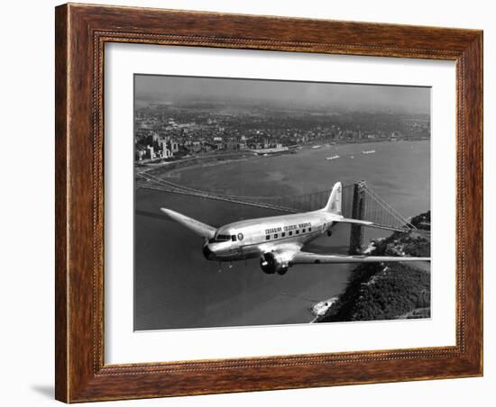 Canadian Colonial Airways Passenger Plane Flys over George Washington Bridge in Montreal, Canada-Margaret Bourke-White-Framed Photographic Print