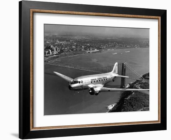 Canadian Colonial Airways Passenger Plane Flys over George Washington Bridge in Montreal, Canada-Margaret Bourke-White-Framed Photographic Print