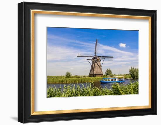 Canal tour boat and windmill in Unesco World Heritage Site, Kinderdijk, Holland, Netherlands.-Michael DeFreitas-Framed Photographic Print