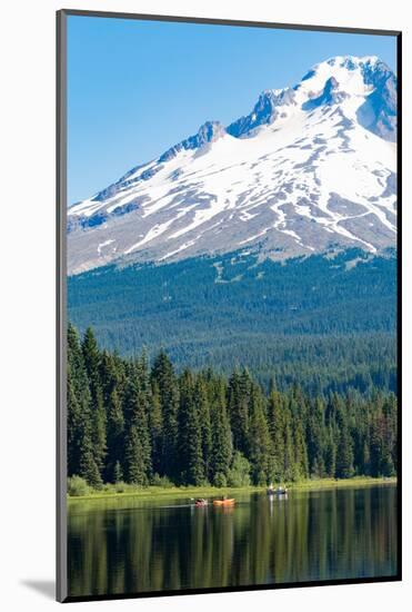 Canoes and rowboat on the still waters of Trillium Lake with Mount Hood, part of the Cascade Range,-Martin Child-Mounted Photographic Print