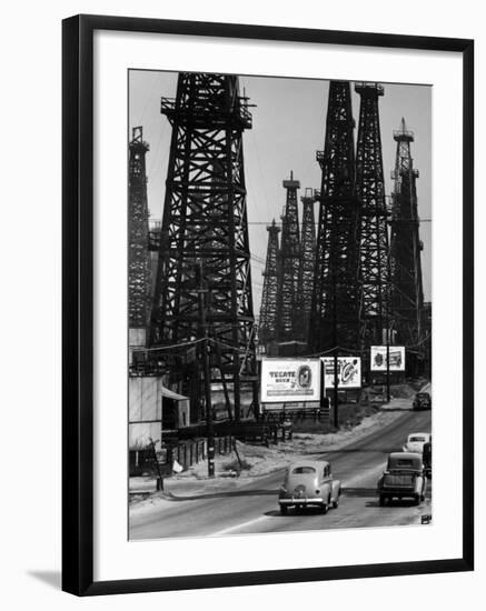 Car Traffic on Highway Next to Advertising Billboards and Oil Well Towers, Signal Hill Oil Field-Andreas Feininger-Framed Premium Photographic Print