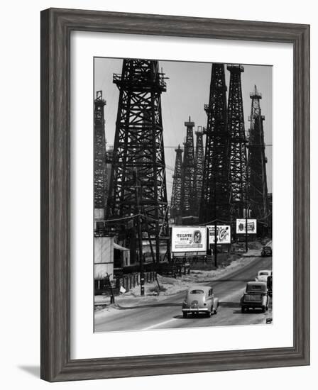 Car Traffic on Highway Next to Advertising Billboards and Oil Well Towers, Signal Hill Oil Field-Andreas Feininger-Framed Photographic Print