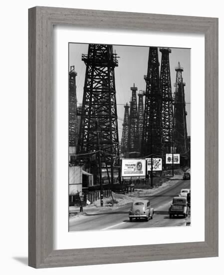 Car Traffic on Highway Next to Advertising Billboards and Oil Well Towers, Signal Hill Oil Field-Andreas Feininger-Framed Photographic Print