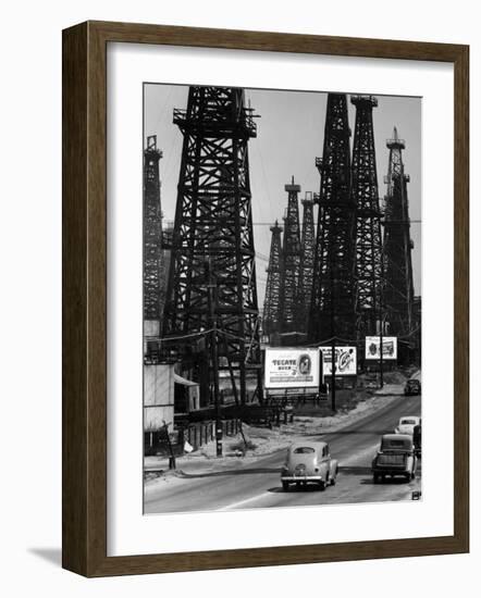 Car Traffic on Highway Next to Advertising Billboards and Oil Well Towers, Signal Hill Oil Field-Andreas Feininger-Framed Photographic Print
