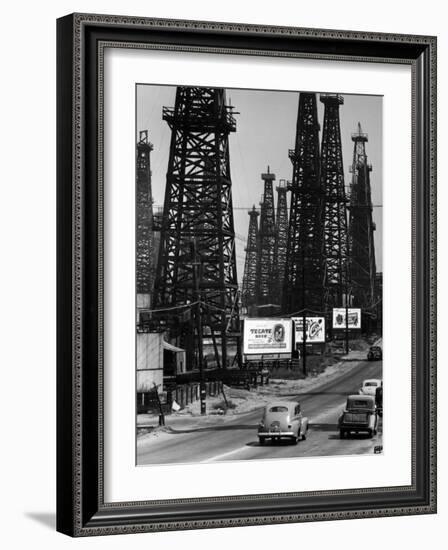 Car Traffic on Highway Next to Advertising Billboards and Oil Well Towers, Signal Hill Oil Field-Andreas Feininger-Framed Photographic Print