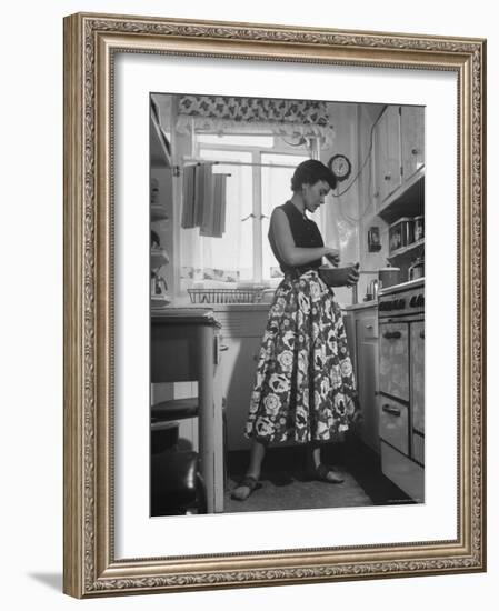 Career Girl Hostedd Joan Wilson in skirt and sleeveless blouse cooking in kitchen-Nina Leen-Framed Photographic Print