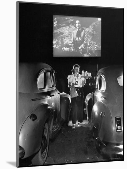 Carhop Carries Tray of Food and Drinks to Car Occupants at Drive-in Movie-Allan Grant-Mounted Photographic Print