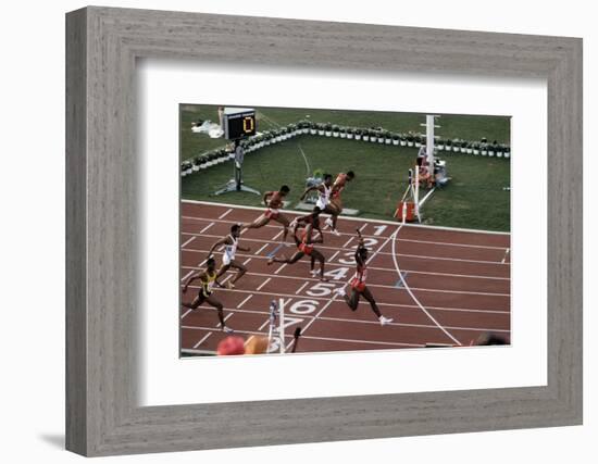 Carl Lewis Crosses the Finishing Line at the Los Angeles Olympics-null-Framed Photographic Print