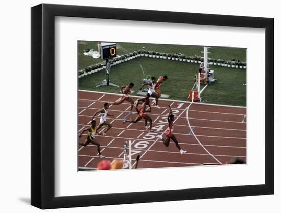 Carl Lewis Crosses the Finishing Line at the Los Angeles Olympics-null-Framed Photographic Print