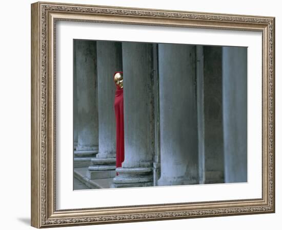 Carnival Model in Red Cape and Gold Mask Peering from Columns in St. Mark's Square, Veneto, Italy-Lee Frost-Framed Photographic Print