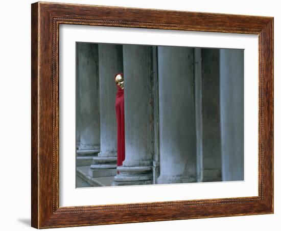 Carnival Model in Red Cape and Gold Mask Peering from Columns in St. Mark's Square, Veneto, Italy-Lee Frost-Framed Photographic Print