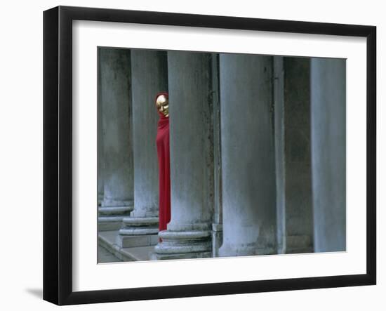 Carnival Model in Red Cape and Gold Mask Peering from Columns in St. Mark's Square, Veneto, Italy-Lee Frost-Framed Photographic Print