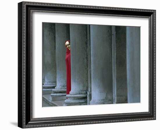 Carnival Model in Red Cape and Gold Mask Peering from Columns in St. Mark's Square, Veneto, Italy-Lee Frost-Framed Photographic Print