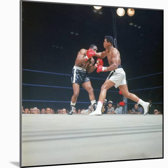 Cassius Clay, aka Muhammad Ali Throwing Famous "Phantom Punch"-George Silk-Mounted Premium Photographic Print