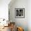 Cat Looks at Goldfish in Bowl-null-Framed Photographic Print displayed on a wall