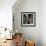 Cat Looks at Goldfish in Bowl-null-Framed Photographic Print displayed on a wall