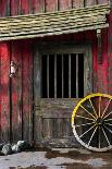 Detail of Old Wagon Wheel next to a Wooden Wild West Typical House-ccaetano-Photographic Print