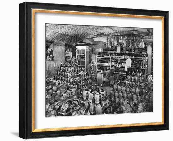 Cellarman at Giannino's Handing Bottle of Wine to Waiter for His Customers-Alfred Eisenstaedt-Framed Photographic Print