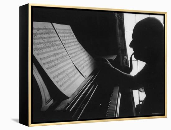 Cellist Pablo Casals at the Piano Studying a Musical Score and Smoking Pipe-Gjon Mili-Framed Premier Image Canvas