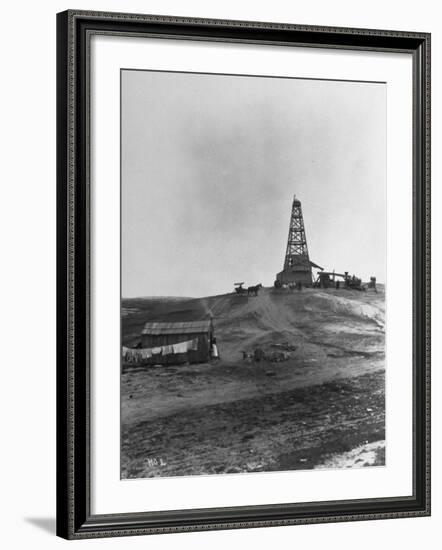 Century Oil Co. Sitting in Field Where Horses and People Mill About Tiny Lone House Sits in Fore.-null-Framed Photographic Print