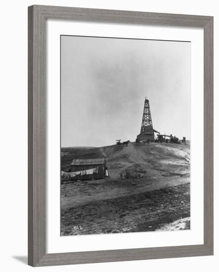 Century Oil Co. Sitting in Field Where Horses and People Mill About Tiny Lone House Sits in Fore.-null-Framed Photographic Print