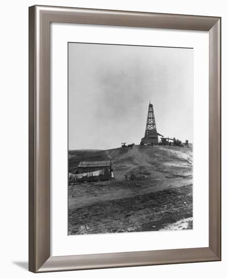 Century Oil Co. Sitting in Field Where Horses and People Mill About Tiny Lone House Sits in Fore.-null-Framed Photographic Print