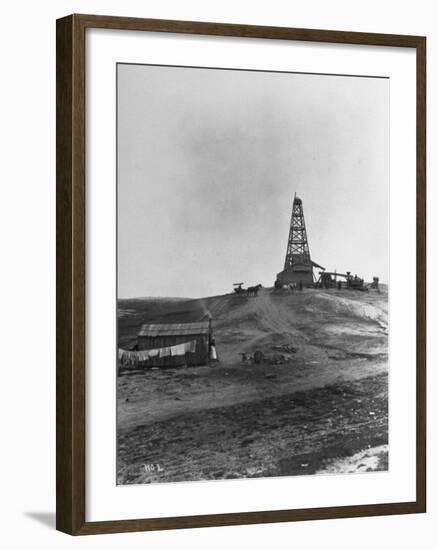 Century Oil Co. Sitting in Field Where Horses and People Mill About Tiny Lone House Sits in Fore.-null-Framed Photographic Print