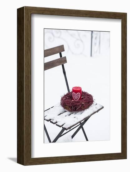 Chair in the Snow with Candle and Wreath-Andrea Haase-Framed Photographic Print