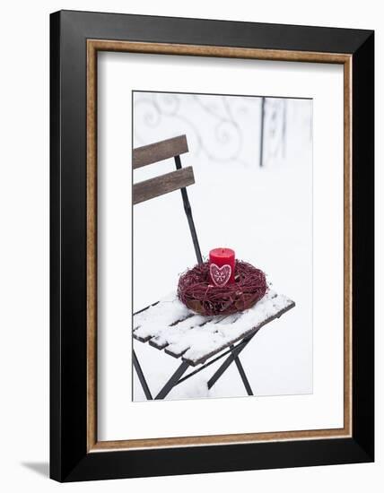 Chair in the Snow with Candle and Wreath-Andrea Haase-Framed Photographic Print