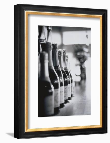 Champagne Bottles in a Row-Walter Bibikow-Framed Photographic Print