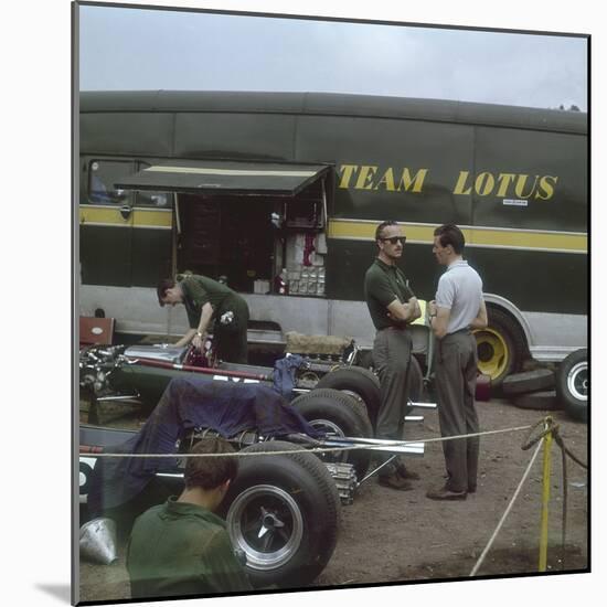 Chapman and Clark Outside the Lotus Team Bus, French Grand Prix, Clermont-Ferrand, France, 1965-null-Mounted Photographic Print