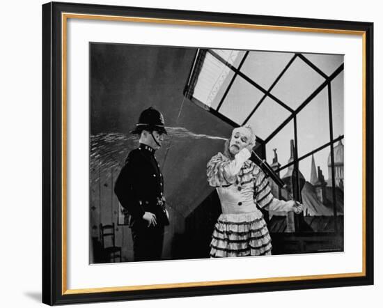 Charlie Chaplin Squirting Water Into Face of Policeman, Scene from Limelight-W^ Eugene Smith-Framed Premium Photographic Print