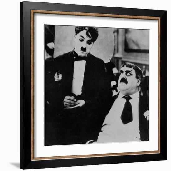 Charlie Chaplin with Eric Campbell in The Rink-null-Framed Premium Photographic Print