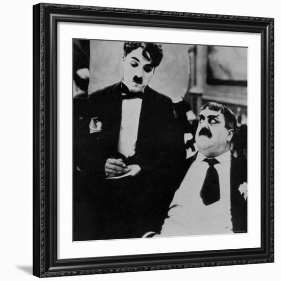 Charlie Chaplin with Eric Campbell in The Rink-null-Framed Premium Photographic Print