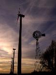 A Group of Wind Turbines are Silhouetted by the Setting Sun-Charlie Riedel-Photographic Print