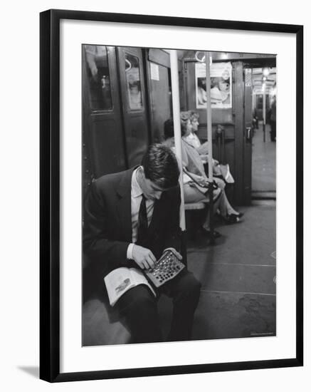 Chess Champion Bobby Fischer Working on His Moves During a Subway Ride-Carl Mydans-Framed Premium Photographic Print