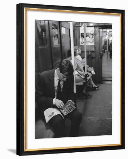 Chess Champion Bobby Fischer Working on His Moves During a Subway Ride-Carl Mydans-Framed Premium Photographic Print