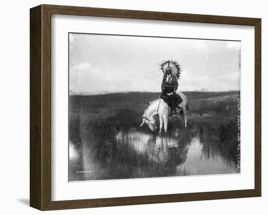 Cheyenne Indian, Wearing Headdress, on Horseback Photograph-Lantern Press-Framed Art Print