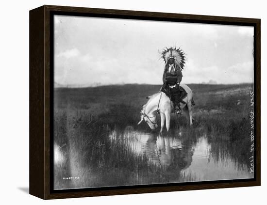 Cheyenne Indian, Wearing Headdress, on Horseback Photograph-Lantern Press-Framed Stretched Canvas