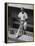 Chicago Cub's Ernie Banks, Stooping in the Dug-Out Holding Two Bats Against Cincinnati Reds-John Dominis-Framed Premier Image Canvas