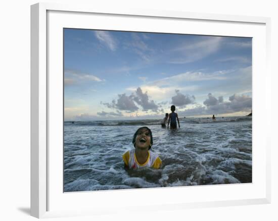 Child as She Plays in the Waves at a Beach in Port Blair, India-null-Framed Photographic Print