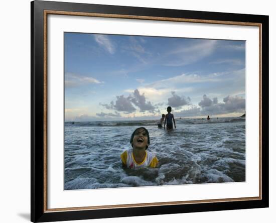 Child as She Plays in the Waves at a Beach in Port Blair, India-null-Framed Photographic Print