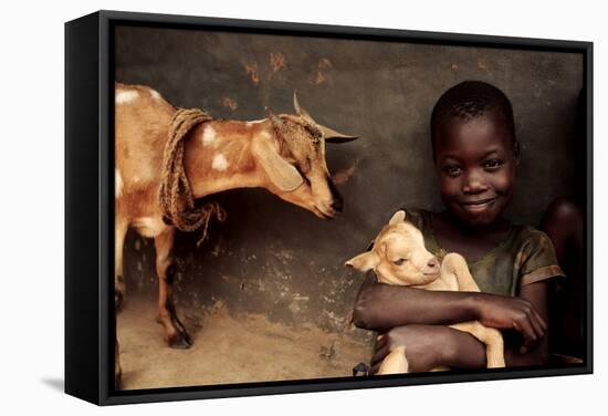 Child Holding a Kid-Mauro Fermariello-Framed Premier Image Canvas