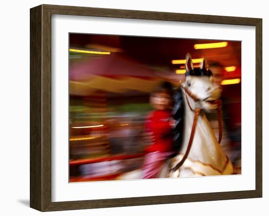 Child on Carousel at Grona Lund Amusement Park, Stockholm, Sweden-Nancy & Steve Ross-Framed Photographic Print