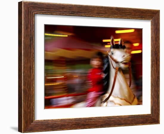 Child on Carousel at Grona Lund Amusement Park, Stockholm, Sweden-Nancy & Steve Ross-Framed Photographic Print