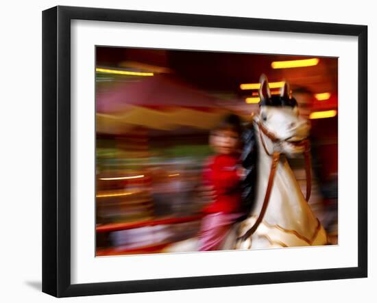 Child on Carousel at Grona Lund Amusement Park, Stockholm, Sweden-Nancy & Steve Ross-Framed Photographic Print