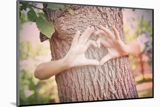 Child's Hands Making a Heart Shape on a Tree Trunk. Instagram Effect-soupstock-Mounted Photographic Print