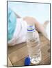 Child Sitting Beside Bottle of Water on Edge of Pool-null-Mounted Photographic Print