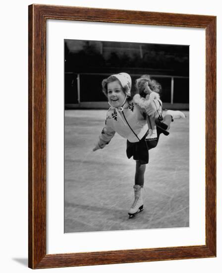 Child Skater Helen Ann Rousselle Holding Doll While Skating across the Ice-null-Framed Photographic Print