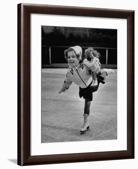 Child Skater Helen Ann Rousselle Holding Doll While Skating across the Ice-null-Framed Photographic Print